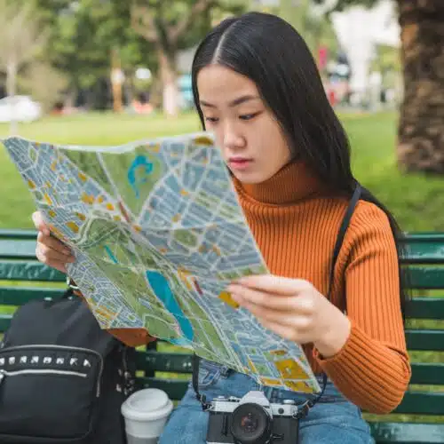 asian woman looking at a map