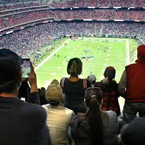 an-audience-of-sports-fans-watching-an-nfl-football-game-in-a-stadium-500x500