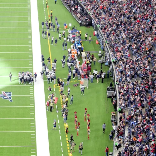 an-audience-of-sports-fans-watching-an-nfl-football-game-in-a-stadium