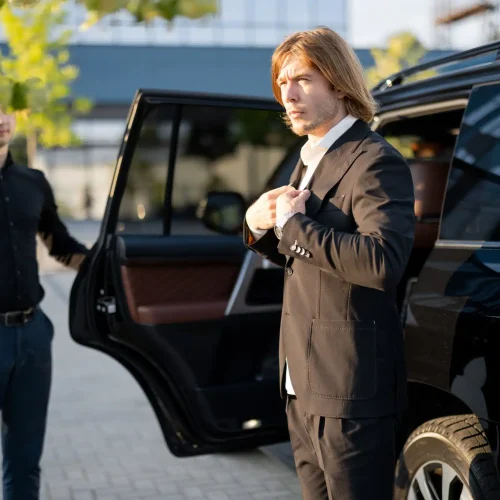 chauffeur-helps-a-businessman-to-get-out-of-the-car
