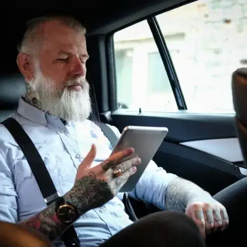old-man-businessman-with-tablet-inside-car-in-daytime-500x500 (1)